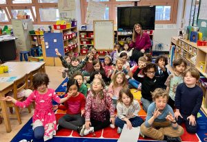Groups of children in their classroom engaged in a mindfulness session. Mindfulness meets Education