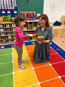 Girl and Veronica Moya participating in a mindfulness class session. Mindfulness in kids