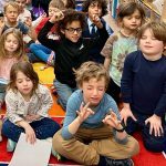 Group of children meditating in a school classroom
